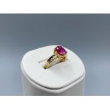 18ct Gold & 1.5ct Oval Ruby Ring with Diamond Accents in very good condition Size N 1/2 weighing 5.2