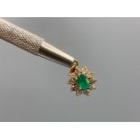 18ct Gold 1/2ct Oval Emerald & Diamond Halo Pendant in very good condition weighing 2.4 grams