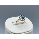 9ct Gold Large Oval Blue Topaz & Diamond Halo Ring in very good condition Size O weighing 2.7 grams