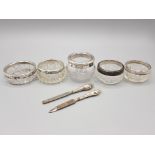 Five silver rimmed and cut glass salts and pots and a part manicure set with silver loaded handles