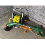 Black & Decker garden strimmer and Gardena hose on reel