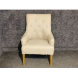 Upholstered button back armchair in cream