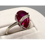 Ladies 9ct white gold red stone ring. Comprising of a pear shaped stone and white gold wrapped