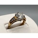 9ct gold solitaire set ring. Comprising of a Round cut cz centre stone and 3 cz stones on each