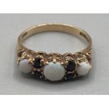 A 9ct yellow gold opal and sapphire ring 2g gross size N 1/2