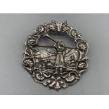 A Norwegian silver brooch depicting a lady blowing a trumpet 24.7g gross