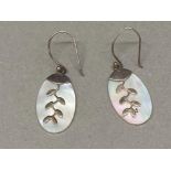 A pair of silver and mother of pearl leaf design earrings