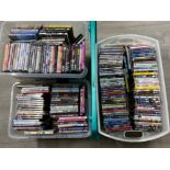 3 storage boxes (1x with lid) containing a large quantity of mixed genre DVDs