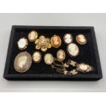 A collection of cameo brooches and a necklace