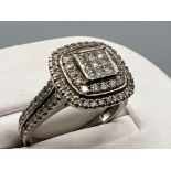 Ladies 18ct white gold diamond cluster halo ring. Featuring a cluster of Princess cut diamonds