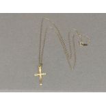 A 9ct yellow gold chain with yellow metal crucifix (faint marks) 1.1g gross