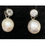 A pair of silver CZ and pearl drop earrings