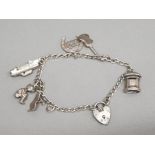 Silver charm bracelet with padlock clasp & 7 charms, 16.4g