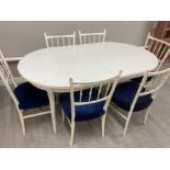 Large white extending dinning table & 6 matching chairs with upholstered blue seat pads by Country