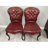 Pair of mahogany framed red leather button back dining chairs