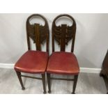 Pair of carved mahogany metal studded chairs