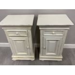 Pair of bedside cupboards both fitted with a single drawer (in white)