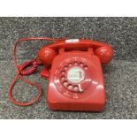A vintage red post office telephone