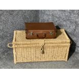 A woven fibre blanket box and a small suitcase