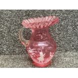A Victorian Mary Gregory cranberry glass jug with enamel decoration 19cm high