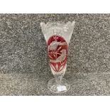 An antique cut glass vase with cranberry overlay