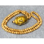 Prayer bead necklace depicting Kuan Yin made of yak bone