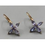 A pair of 10k yellow gold and purple stone earrings 1.5g gross