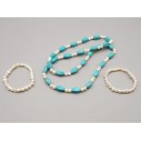 A pearl and turquoise necklace and two pearl bracelets