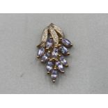 A 9ct yellow gold diamond and purple stone pendant 2g gross