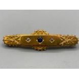 A 15ct yellow gold Victorian style brooch with central blue stone flanked by two diamonds 4.7g