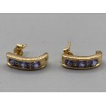 A pair of 18ct yellow gold diamond and purple stone earrings 2.9g gross