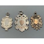Three ornate silver shields 39.1g