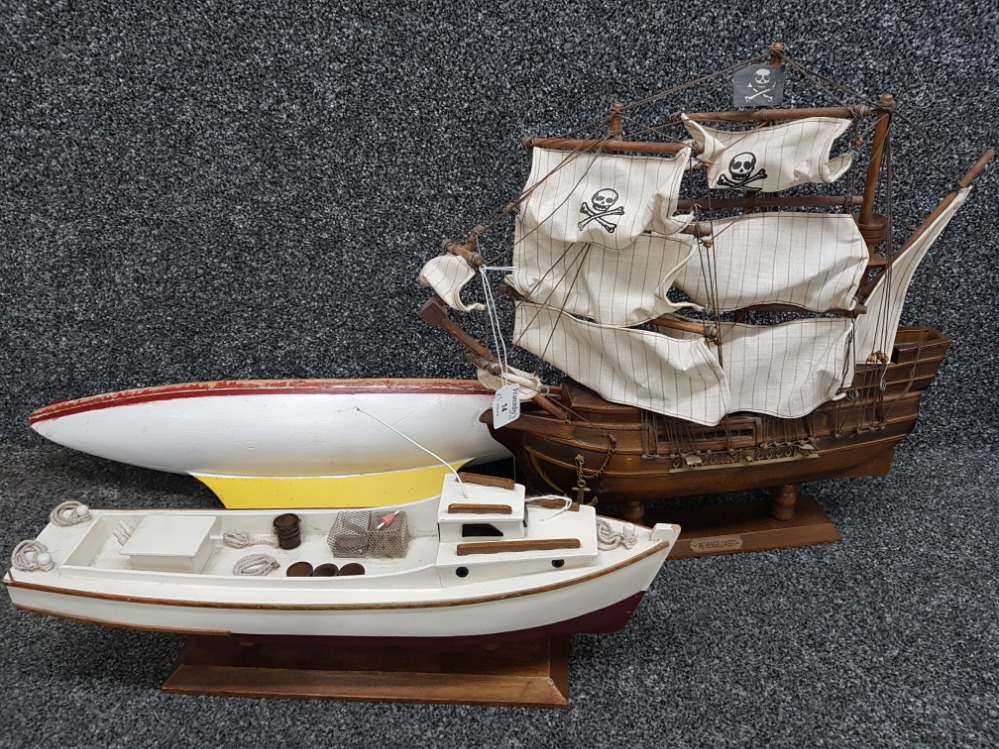 A model galleon pirate ship and two boats