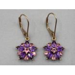 A pair of 9ct yellow gold pink and purple stone earrings of floral design 2.1g gross