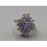 A 9ct yellow gold purple stone and diamond cluster ring size U 3.3g gross