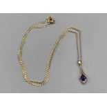 A 9ct yellow gold diamond and purple stone pendant on 9ct gold chain 2.2g gross