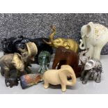 Box containing a variety of elephant ornaments including brass, glass & soapstone