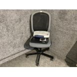 A swivel office chair, ring binder and scanner