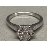 A white gold and diamond cluster ring size M .10ct 2.8g gross