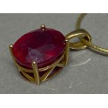 9ct yellow gold & red stone pendant 2.5g gross on silver 925 gilt chain 2.8g