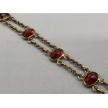 Ladies 9ct gold Garnet bracelet. Comprising of 10 oval shaped garnets 5.2g