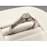 Ladies 9ct white gold diamond ring. Comprising of a diamond set in centre and 3 diamonds set each