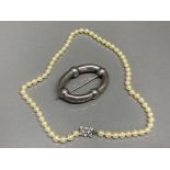 Cultured Pearl necklace together with a white metal scarf brooch