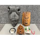 An African carved wooden mask and four others various designs