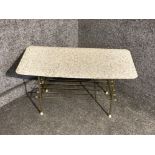 A retro coffee table with metal supports and under tier 76cm wide