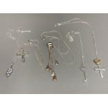 Five silver pendants on silver chains to include two crucifix 37g gross