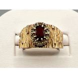 Ladies 9ct gold garnet and white stone ring. 4.6g size O