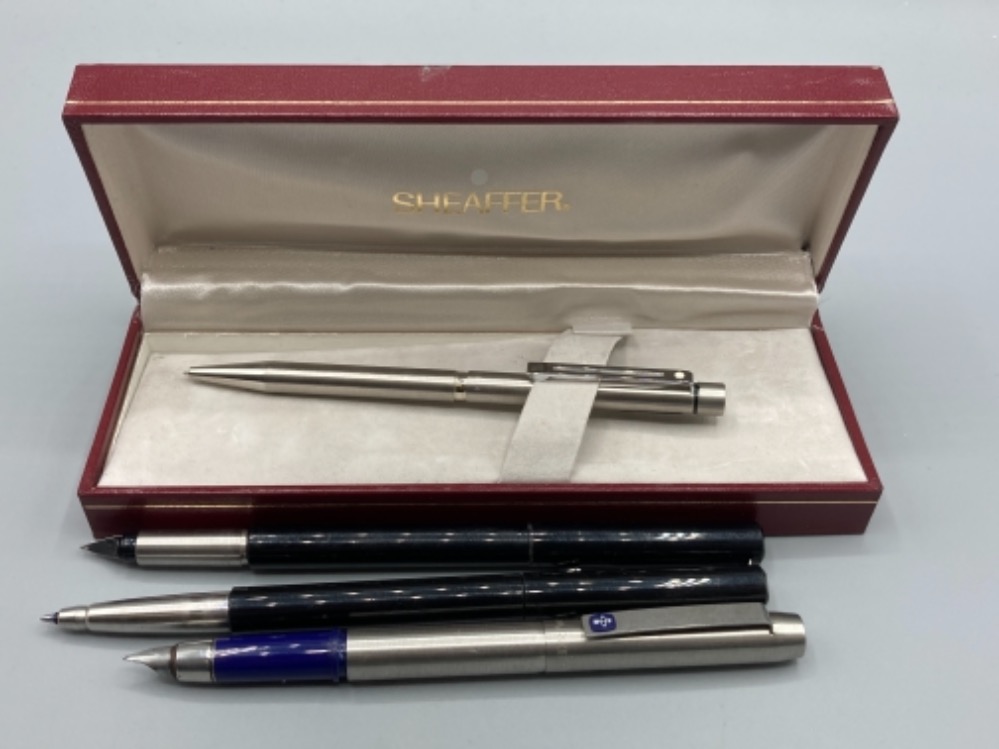 A Sheaffer ball point pen, boxed and three Parker pens