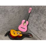 2 acoustic guitars (one in pink with indistinct signature inside)