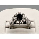 Ladies 18ct white gold sapphire and diamond cluster ring. Comprising of a black sapphire with